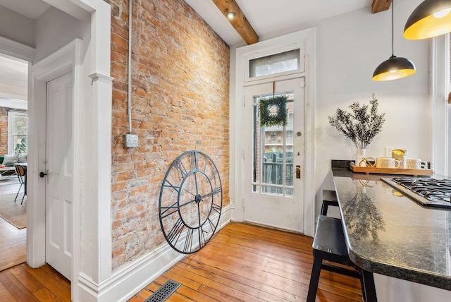 1030 Jaeger St, Columbus, OH 43206 - entryway with beam ceiling, wood-type flooring, plenty of natural light, and brick wall
