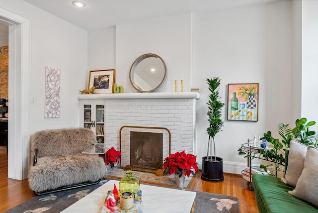 1030 Jaeger St, Columbus, OH 43206 - living room with wood finished floors, a brick fireplace, and recessed lighting