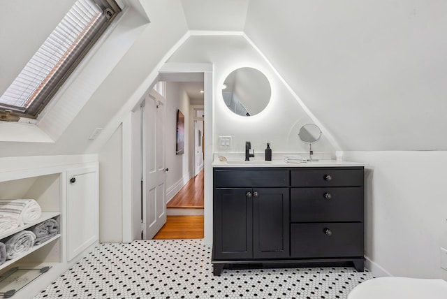 1030 Jaeger St, Columbus, OH 43206 - bathroom featuring vanity, vaulted ceiling, and a skylight