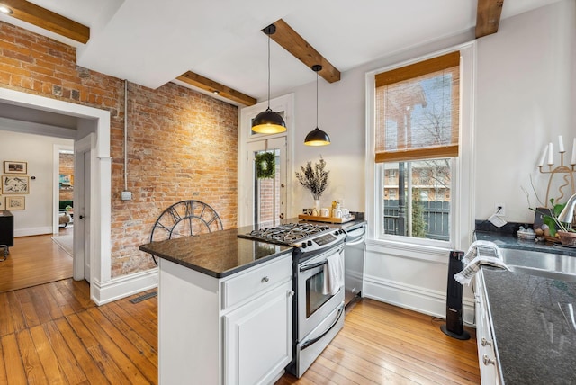 1030 Jaeger St, Columbus, OH 43206 - kitchen with appliances with stainless steel finishes, beam ceiling, a peninsula, hardwood / wood-style flooring, and white cabinetry