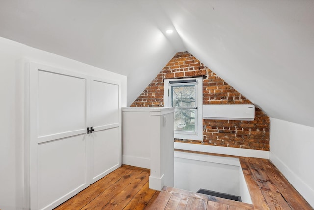 1030 Jaeger St, Columbus, OH 43206 - additional living space featuring wood-type flooring, lofted ceiling, and brick wall