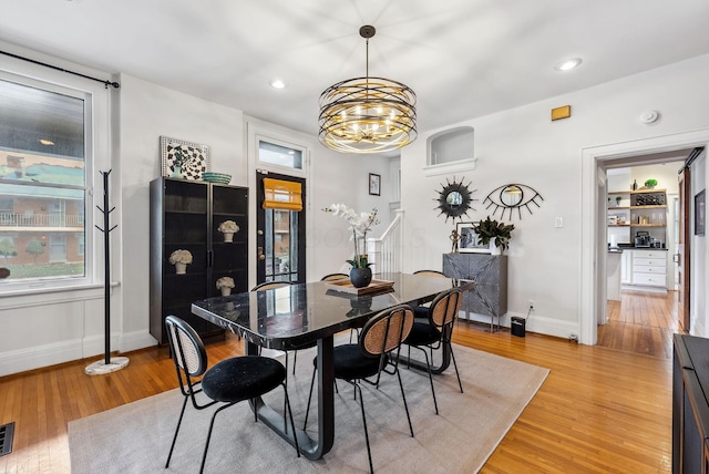 1030 Jaeger St, Columbus, OH 43206 - dining room with light wood-style flooring, a chandelier, and recessed lighting