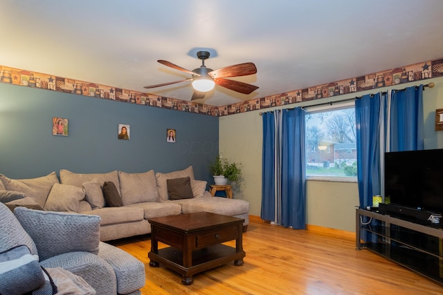 living room featuring hardwood / wood-style floors and ceiling fan