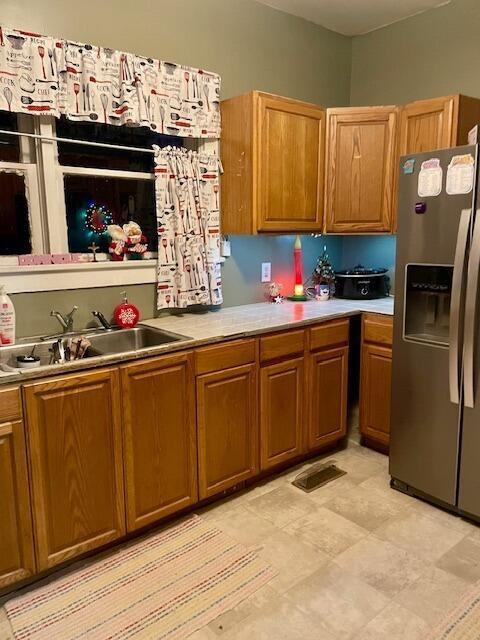 kitchen with stainless steel fridge with ice dispenser and sink