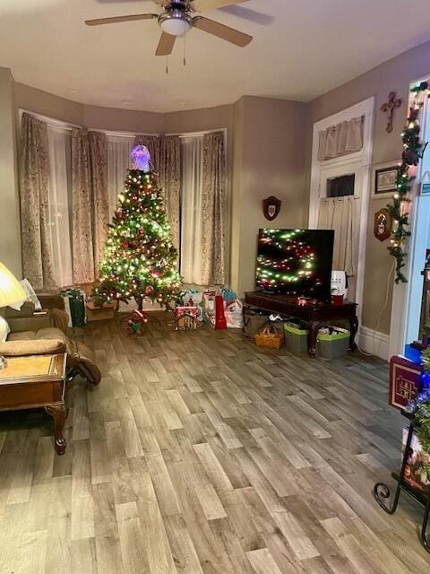 sitting room with ceiling fan and hardwood / wood-style floors