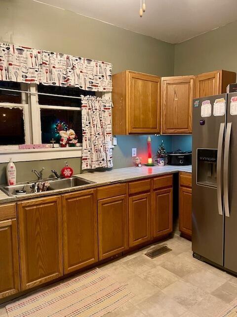 kitchen with stainless steel fridge with ice dispenser and sink