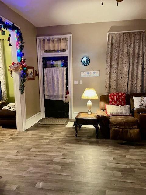 sitting room featuring wood-type flooring and ceiling fan