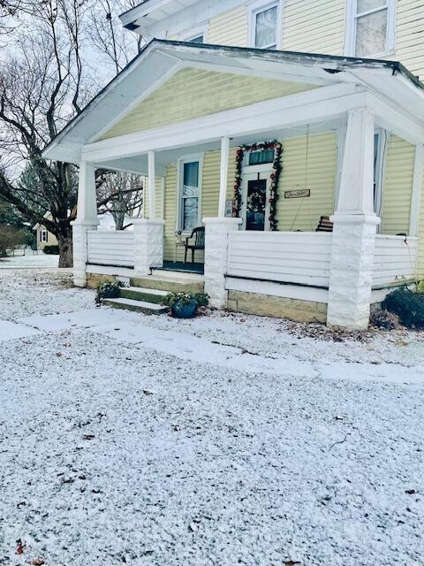 view of snow covered property entrance