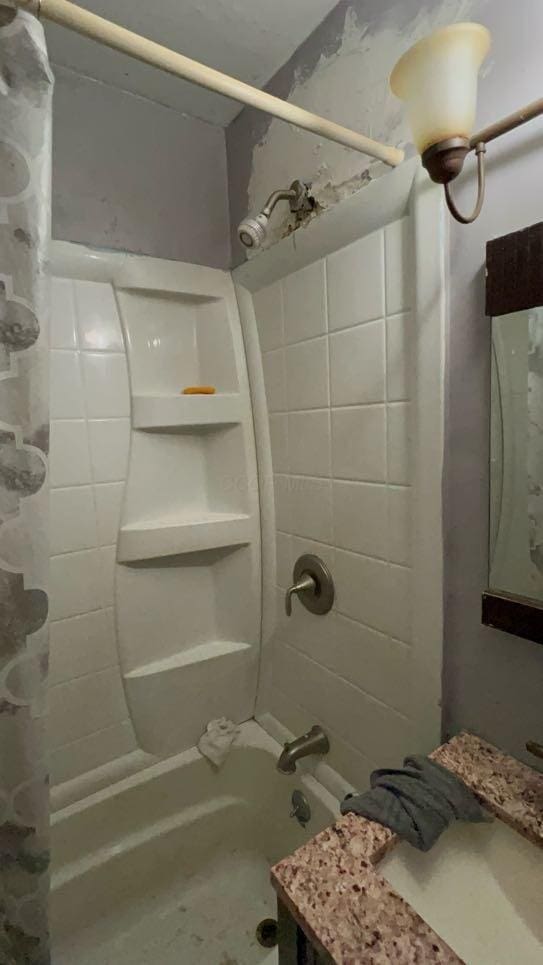 bathroom with shower / bath combo with shower curtain and sink