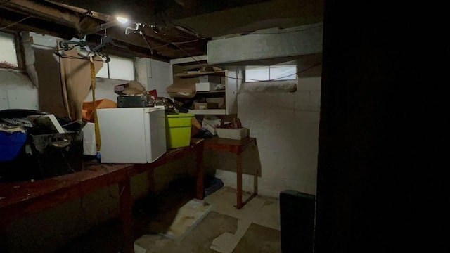 basement featuring white fridge