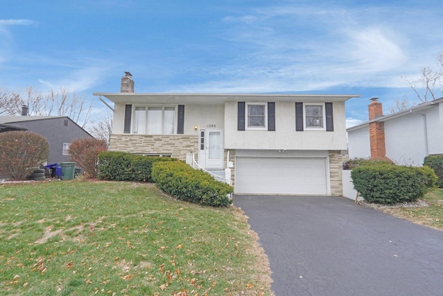 view of front of house with a front lawn and a garage