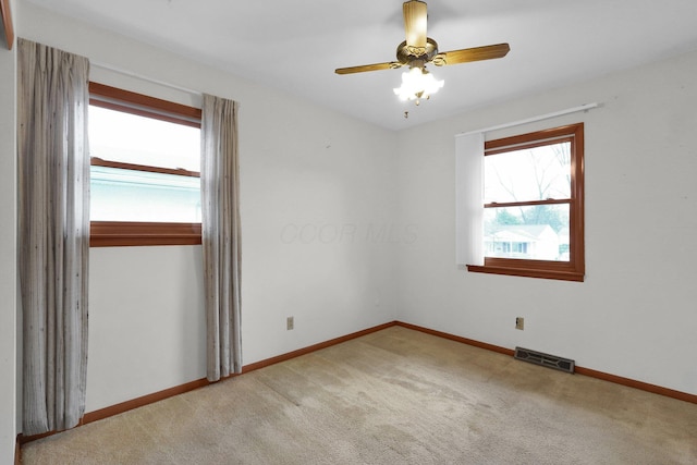 unfurnished room featuring ceiling fan and carpet floors