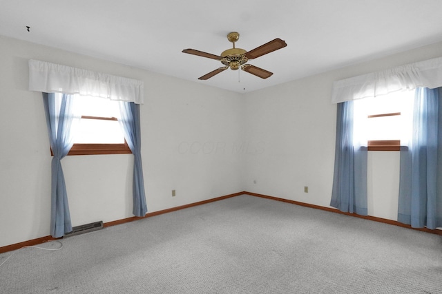 carpeted empty room featuring ceiling fan