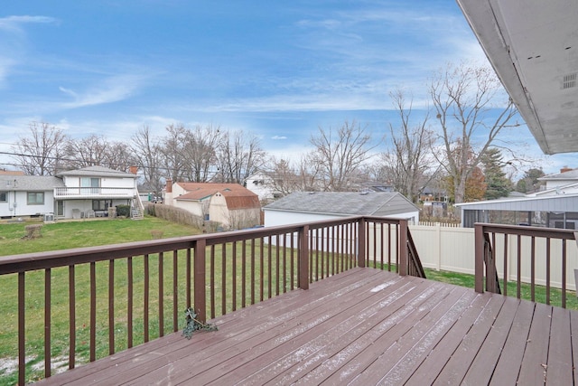 wooden deck featuring a lawn