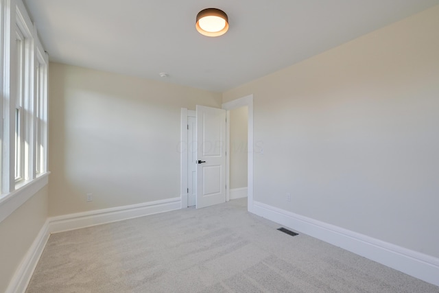 empty room with light colored carpet