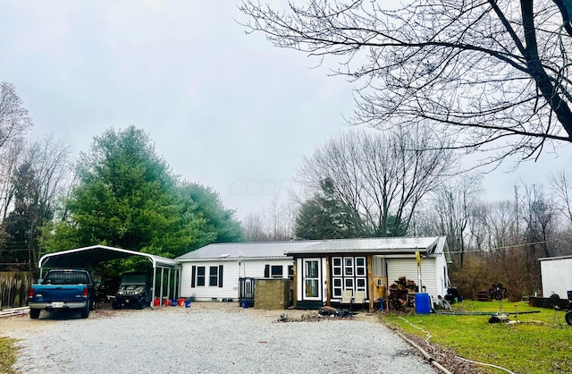 view of front of property with a front yard and a carport