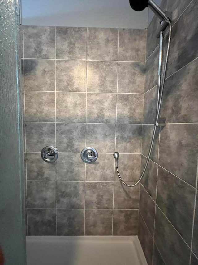 bathroom with tiled shower