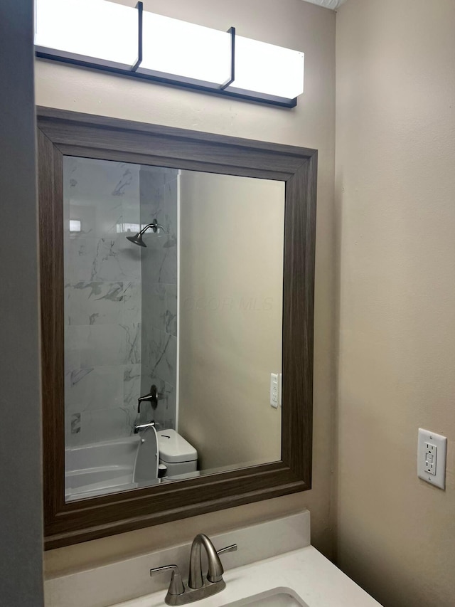 full bath with tub / shower combination, vanity, and toilet