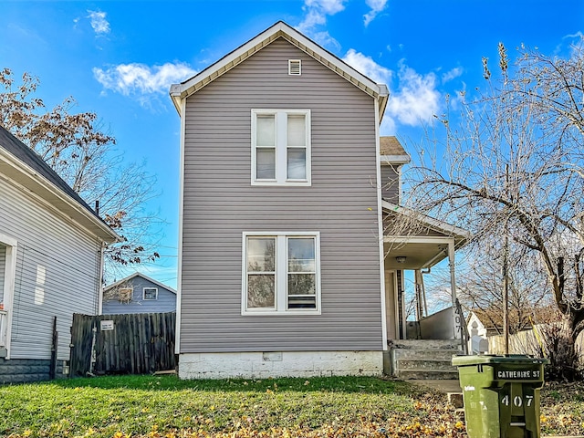 view of side of home with a yard