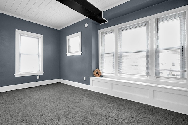 carpeted spare room featuring wood ceiling and beam ceiling