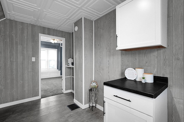 bathroom featuring wood-type flooring and wood walls