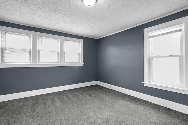 carpeted empty room with a textured ceiling