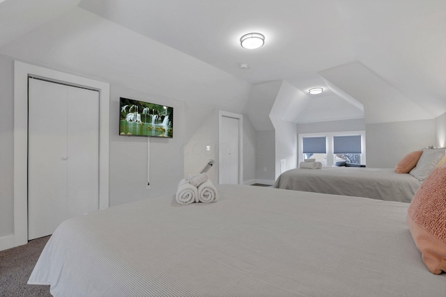 carpeted bedroom featuring vaulted ceiling