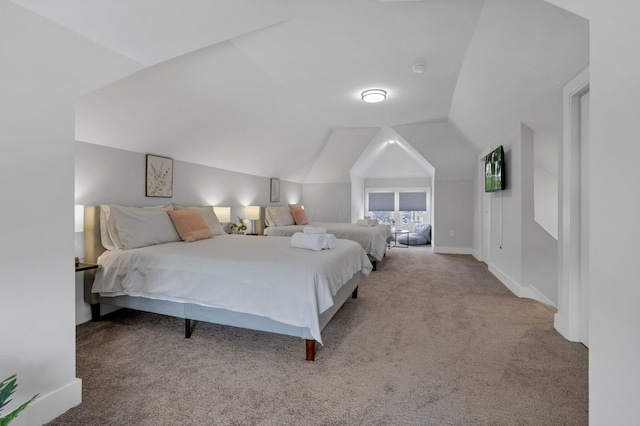 bedroom with light carpet and lofted ceiling