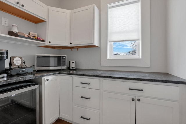 kitchen featuring white cabinetry and beverage cooler