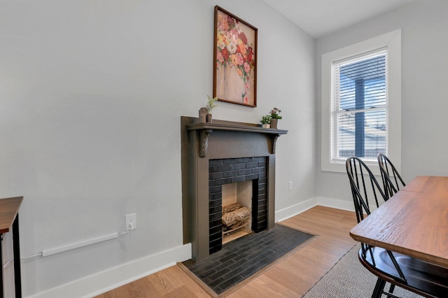 office space with a fireplace and light wood-type flooring