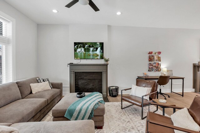 living room with light hardwood / wood-style floors and ceiling fan