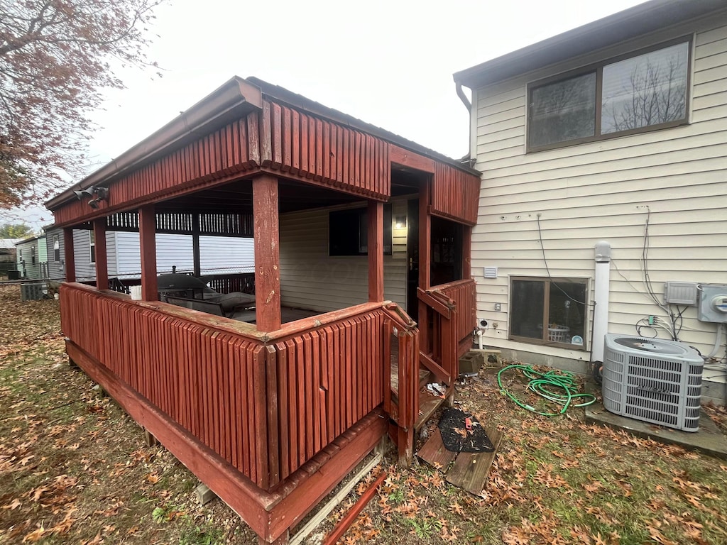 wooden terrace featuring cooling unit