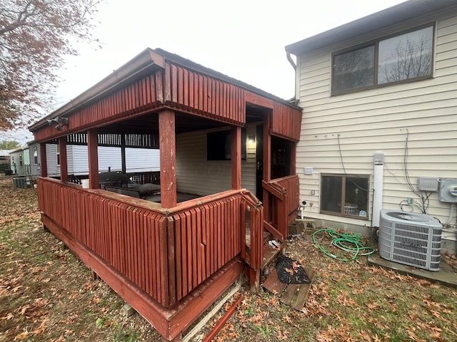 wooden terrace featuring cooling unit