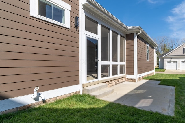 view of side of property with a yard and a patio area