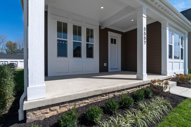 view of exterior entry with a porch