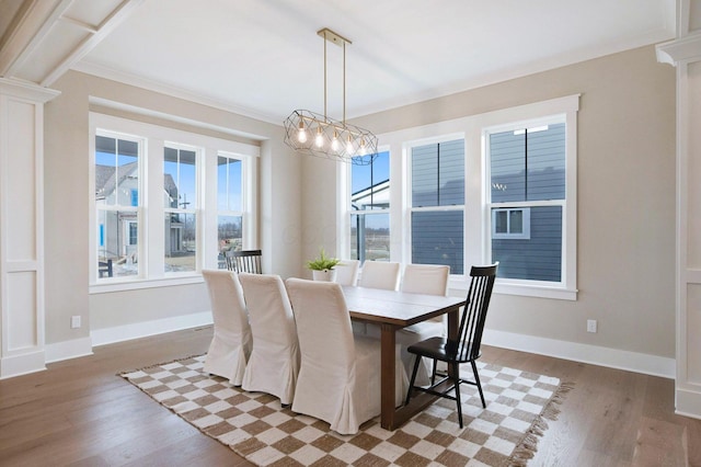 dining area featuring a chandelier, crown molding, and dark wood-type flooring