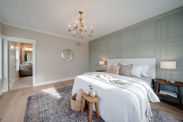 bedroom featuring light wood-type flooring, connected bathroom, an inviting chandelier, and crown molding