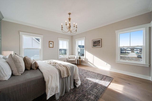 bedroom featuring light hardwood / wood-style flooring, a notable chandelier, and crown molding