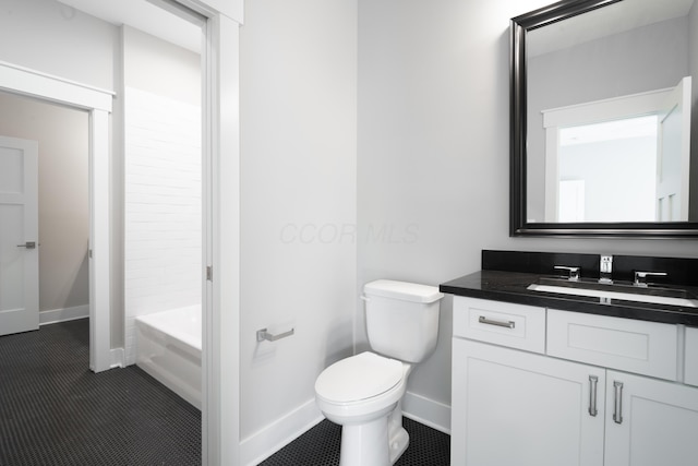 bathroom featuring tile patterned flooring, vanity, and toilet