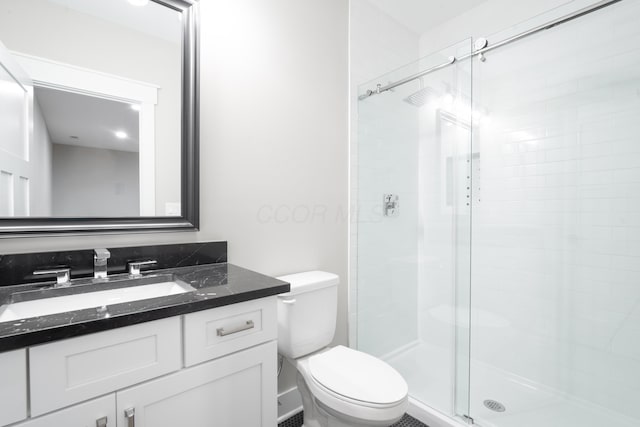 bathroom with walk in shower, vanity, and toilet