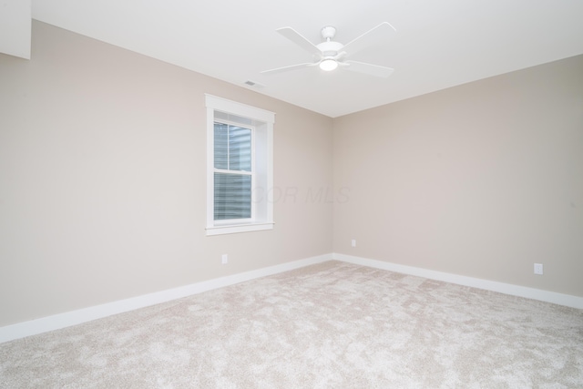 empty room featuring carpet floors and ceiling fan