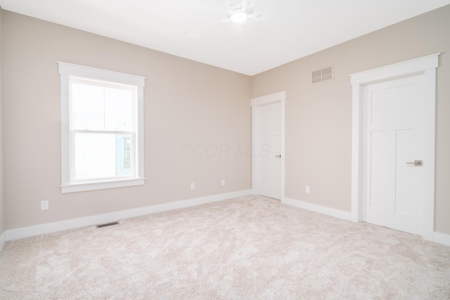 unfurnished room featuring light carpet and ceiling fan