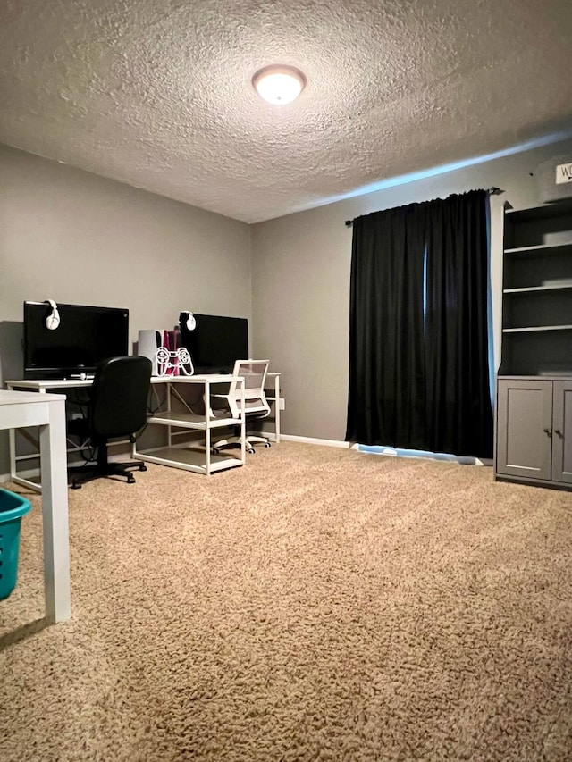 home office featuring carpet and a textured ceiling