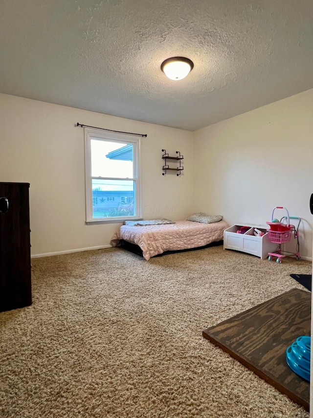 bedroom with carpet flooring and a textured ceiling