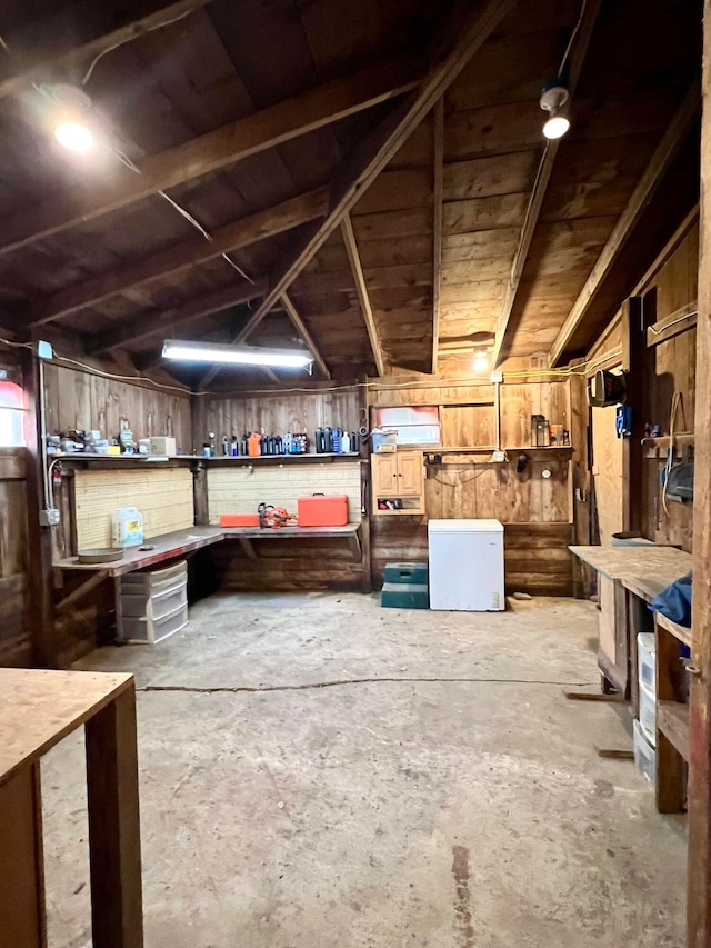 basement with a workshop area and fridge