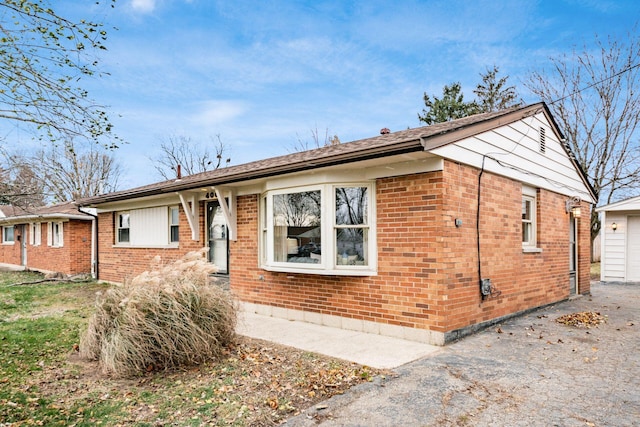 single story home featuring an outbuilding and a garage