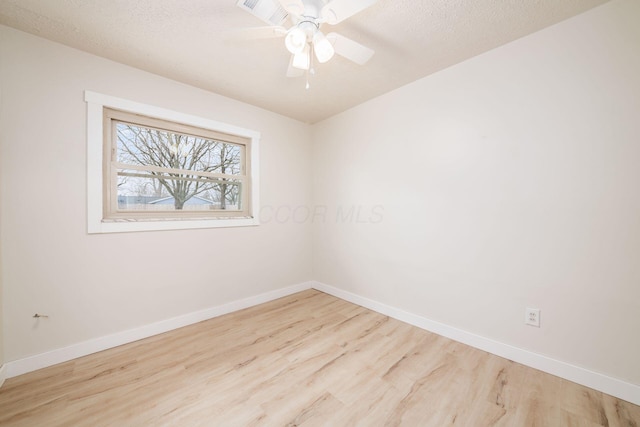 empty room with a textured ceiling, light hardwood / wood-style flooring, and ceiling fan