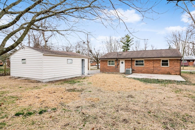 back of property with central air condition unit, a patio, and an outdoor structure