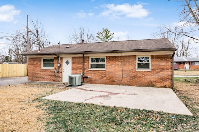 back of property featuring a yard, cooling unit, and a patio area