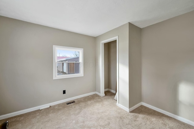 unfurnished bedroom with light colored carpet